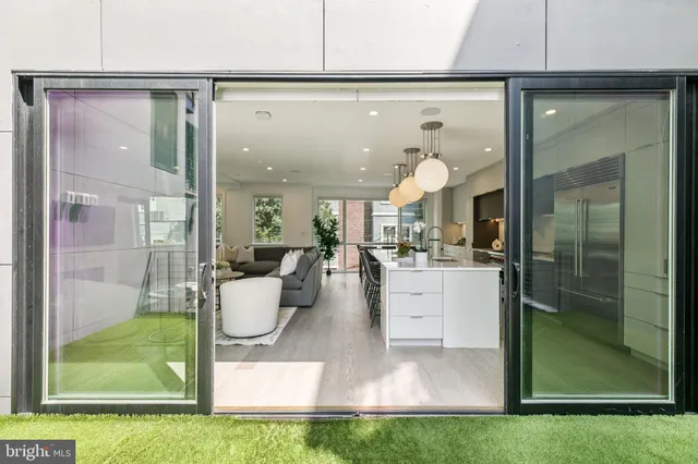 a kitchen with white cabinets and window