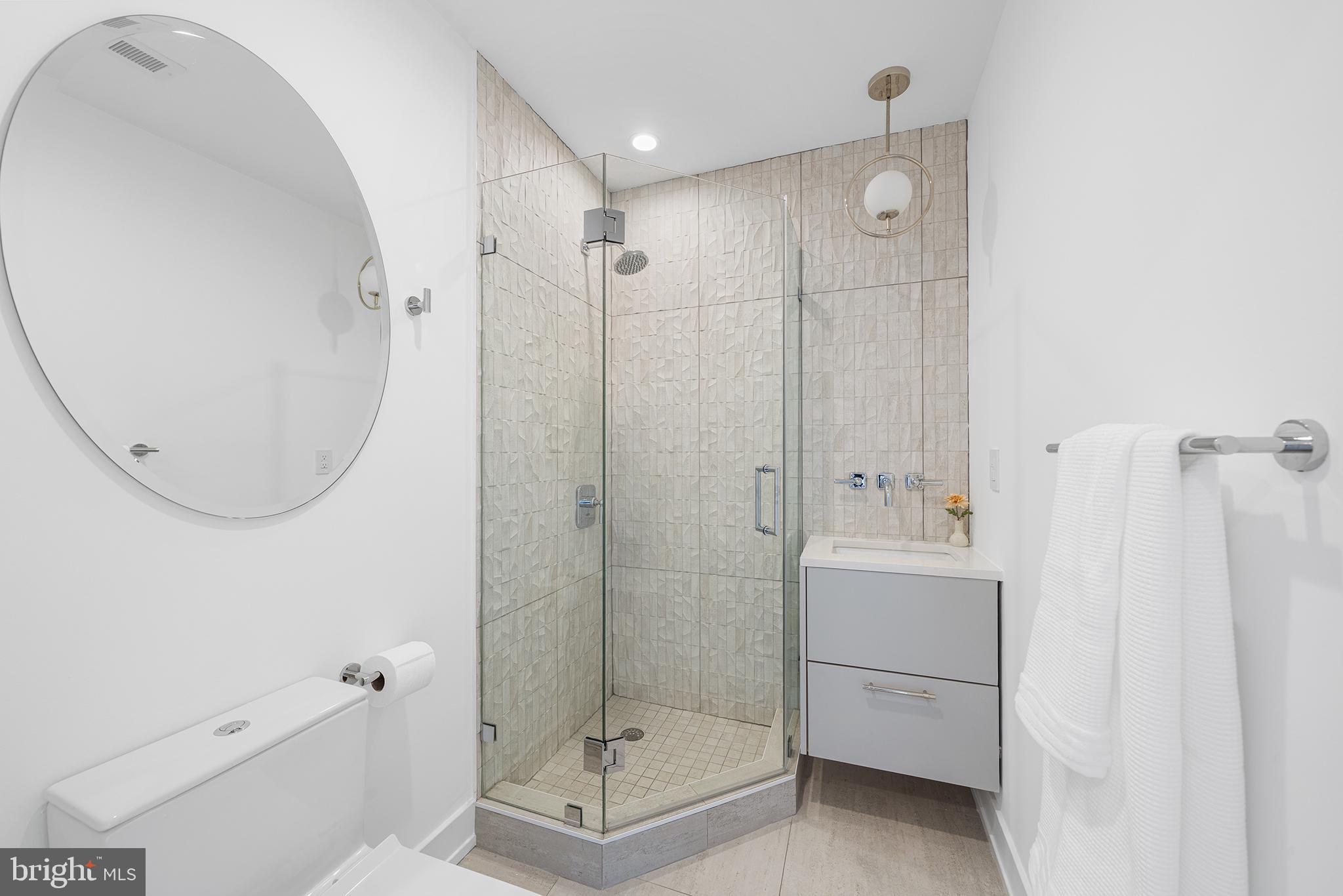 618 South Clarion Street Philadelphia, PA 19147 - Photo 36 of 65 a bathroom with a shower a mirror and a sink