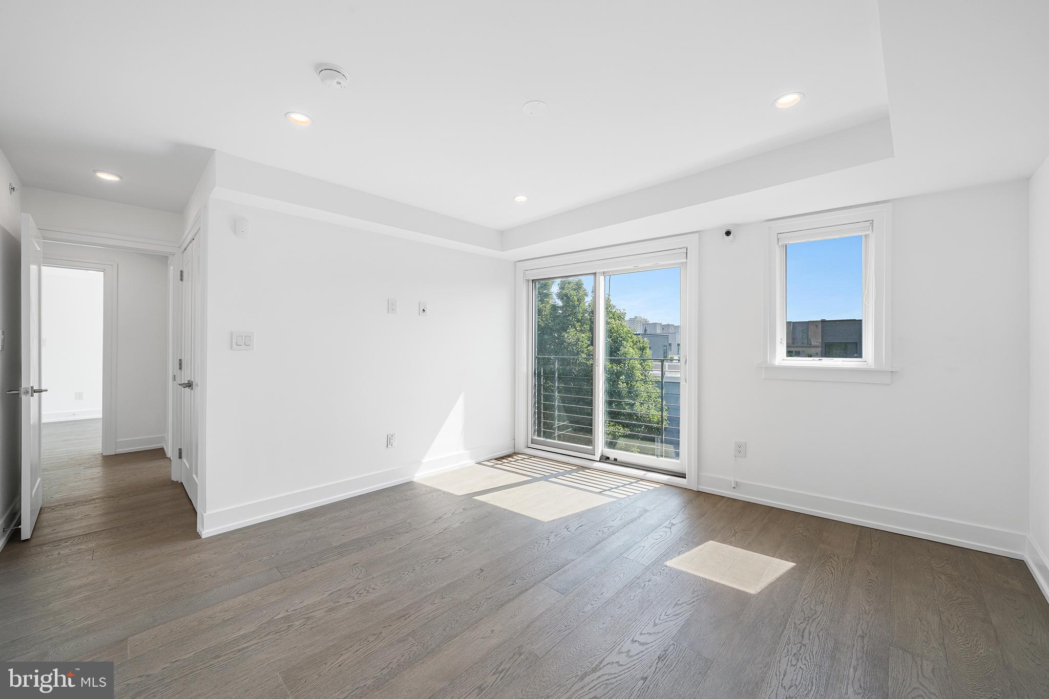 618 South Clarion Street Philadelphia, PA 19147 - Photo 39 of 65 an empty room with wooden floor and windows