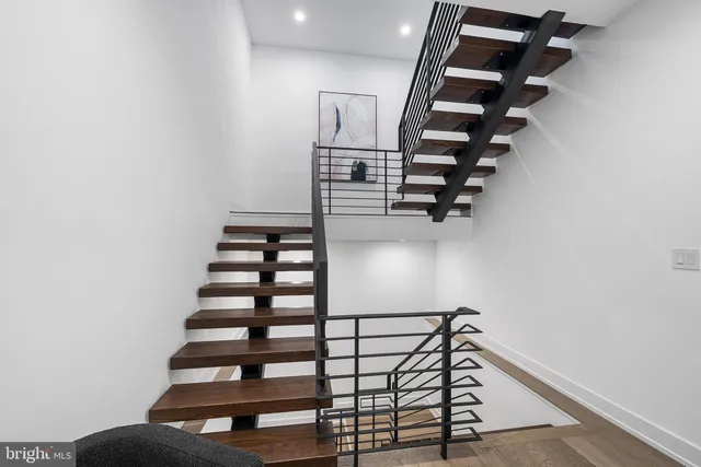 a living room with fireplace furniture and a large window