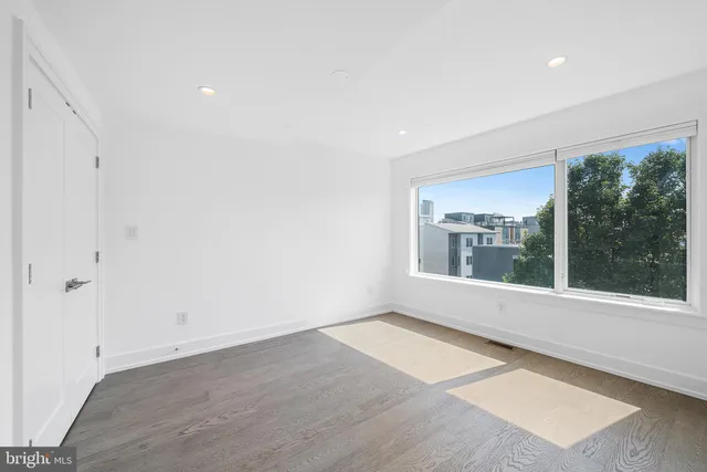 a view of an empty room with a kitchen