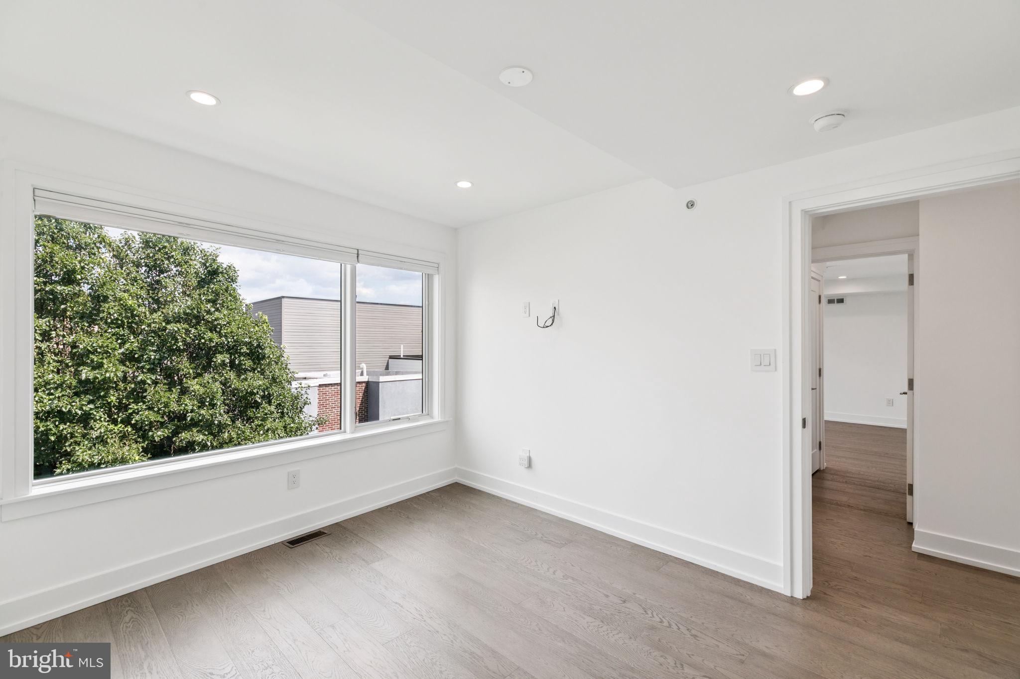 618 South Clarion Street Philadelphia, PA 19147 - Photo 43 of 65 an empty room with wooden floor and windows