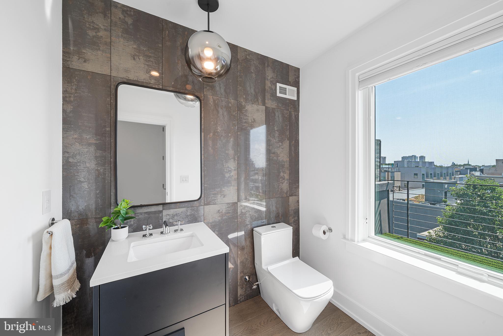 618 South Clarion Street Philadelphia, PA 19147 - Photo 50 of 65 a bathroom with a toilet sink and mirror