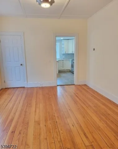 a view of an empty room and wooden floor