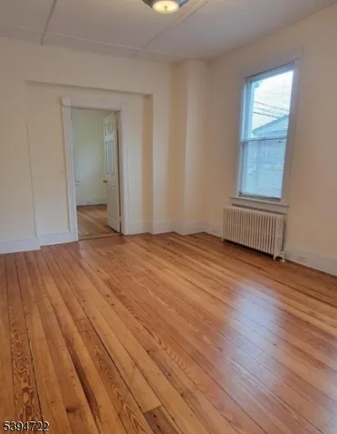 a view of an empty room and wooden floor