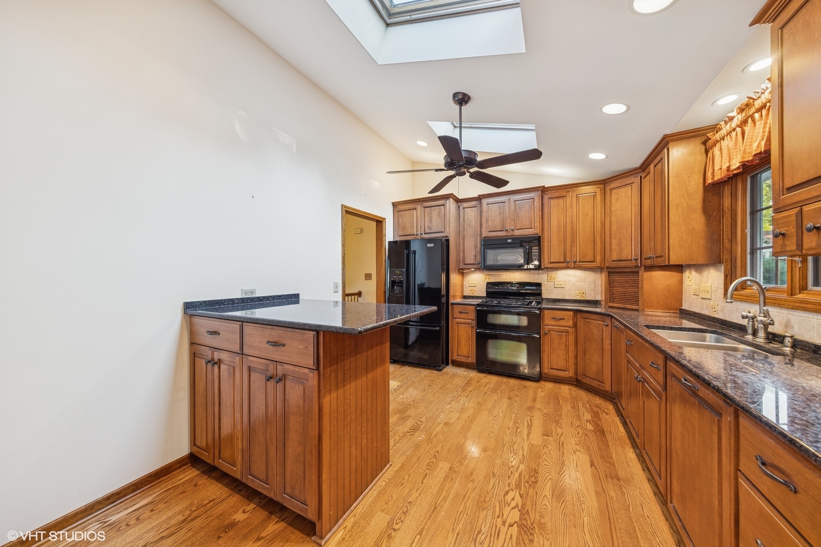 6901 Meadow Crest Drive Downers Grove, IL 60516 - Photo 11 of 42 a kitchen with stainless steel appliances granite countertop a refrigerator a sink dishwasher a stove and a dining table with wooden floor