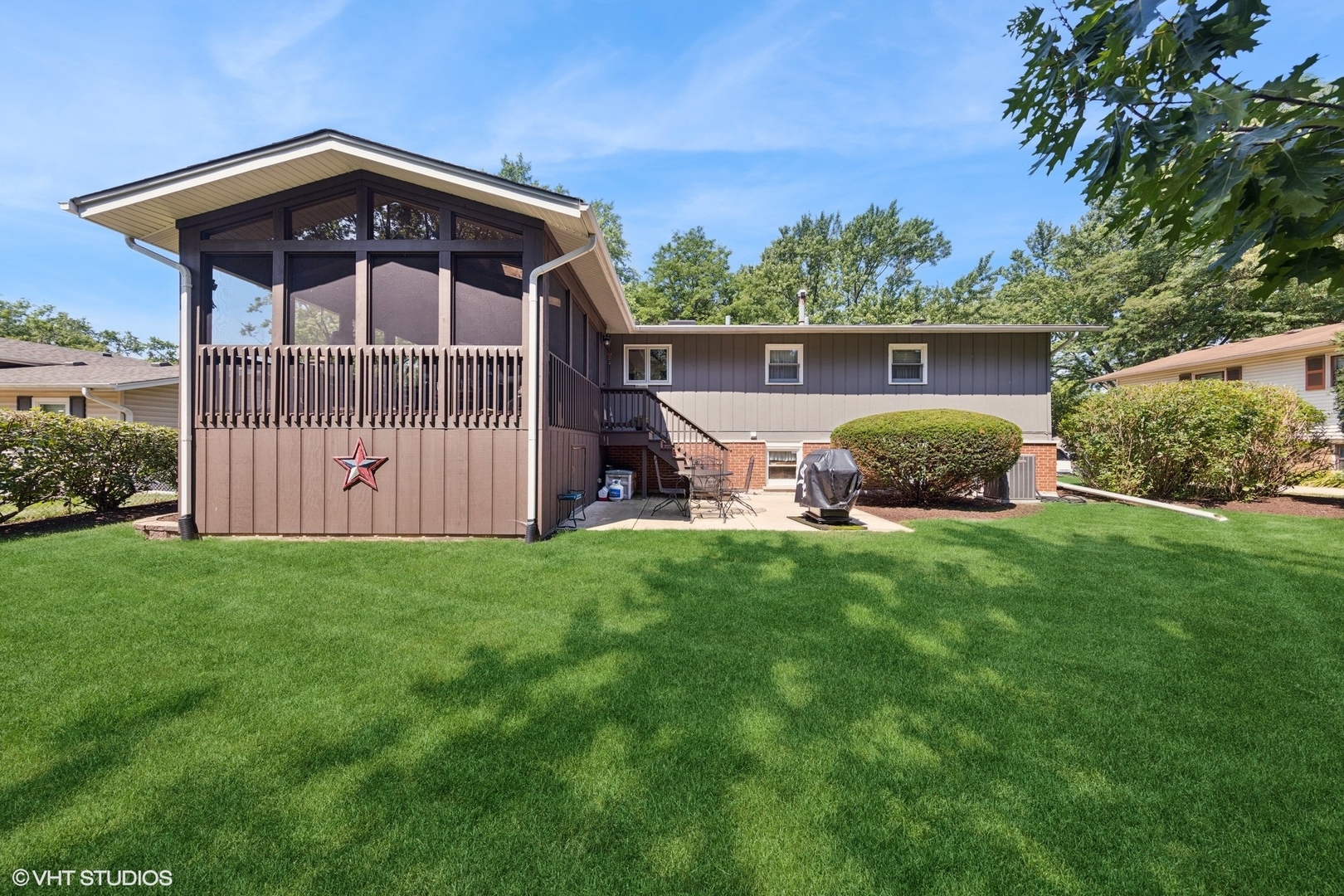6901 Meadow Crest Drive Downers Grove, IL 60516 - Photo 30 of 42 a front view of a house with a yard and garage