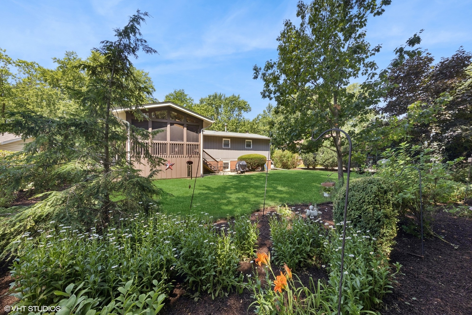6901 Meadow Crest Drive Downers Grove, IL 60516 - Photo 34 of 42 a front view of a house with garden