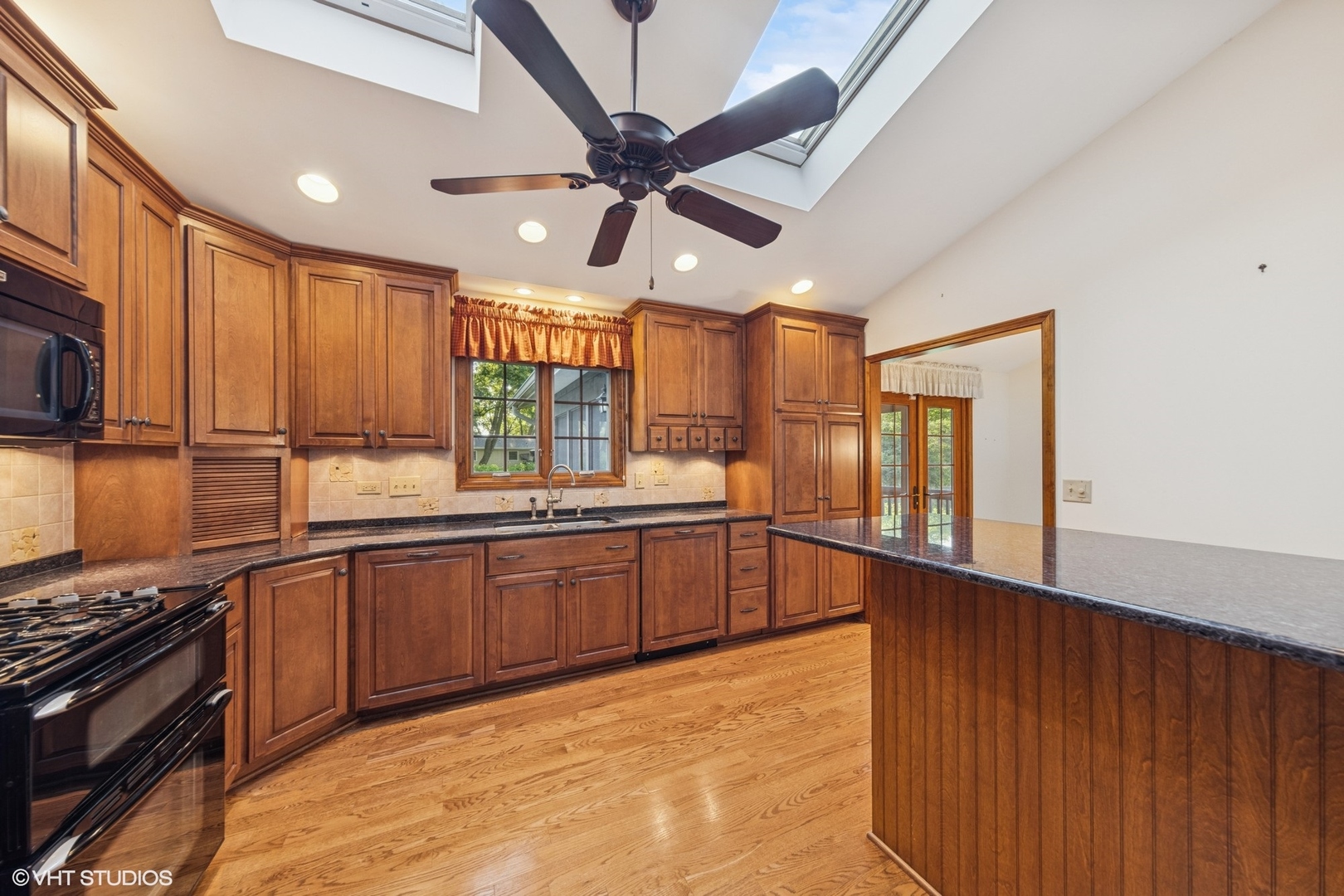 6901 Meadow Crest Drive Downers Grove, IL 60516 - Photo 10 of 42 a large kitchen with stainless steel appliances granite countertop a stove and a sink