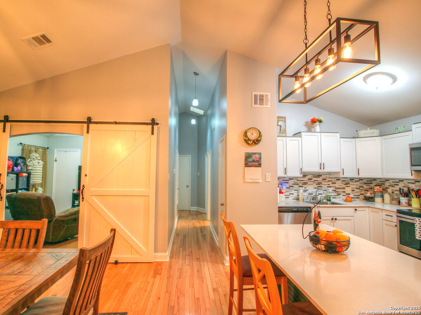 213 Bluebonnet Road La Vernia, TX 78121 - Photo 12 of 48 a very nice looking dining room with a large dining table and chairs with the view of kitchen