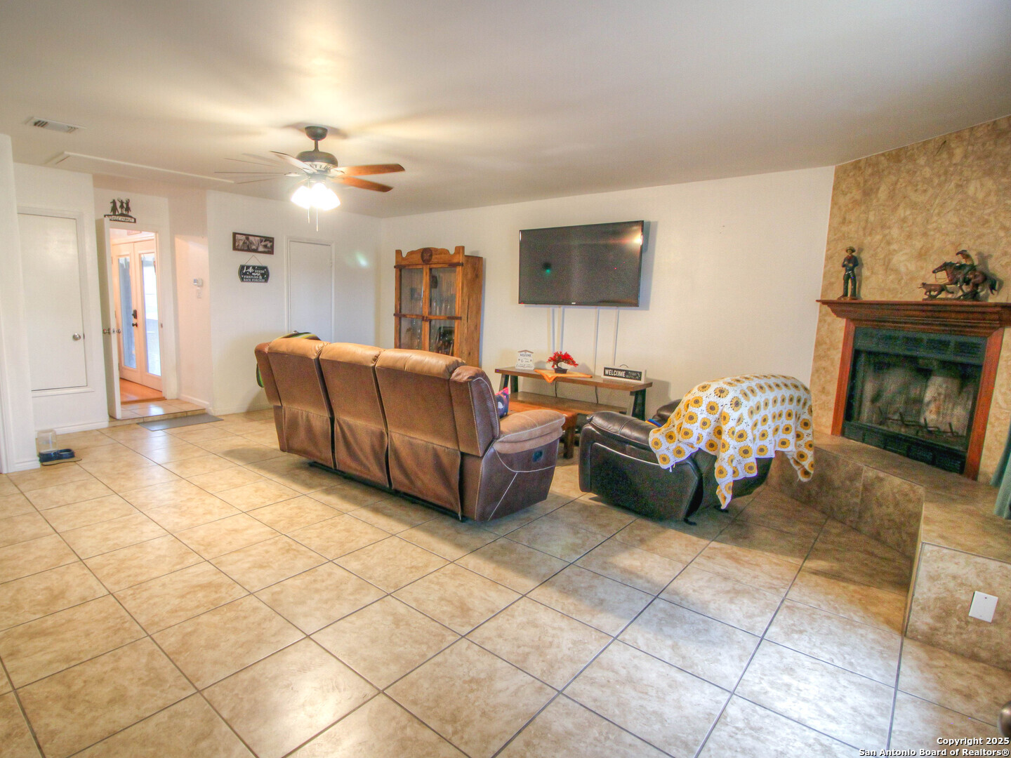 213 Bluebonnet Road La Vernia, TX 78121 - Photo 14 of 48 a living room with furniture and a fireplace