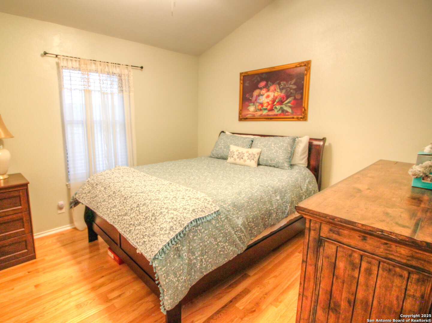 213 Bluebonnet Road La Vernia, TX 78121 - Photo 20 of 48 a bedroom with a bed and a painting on the wall