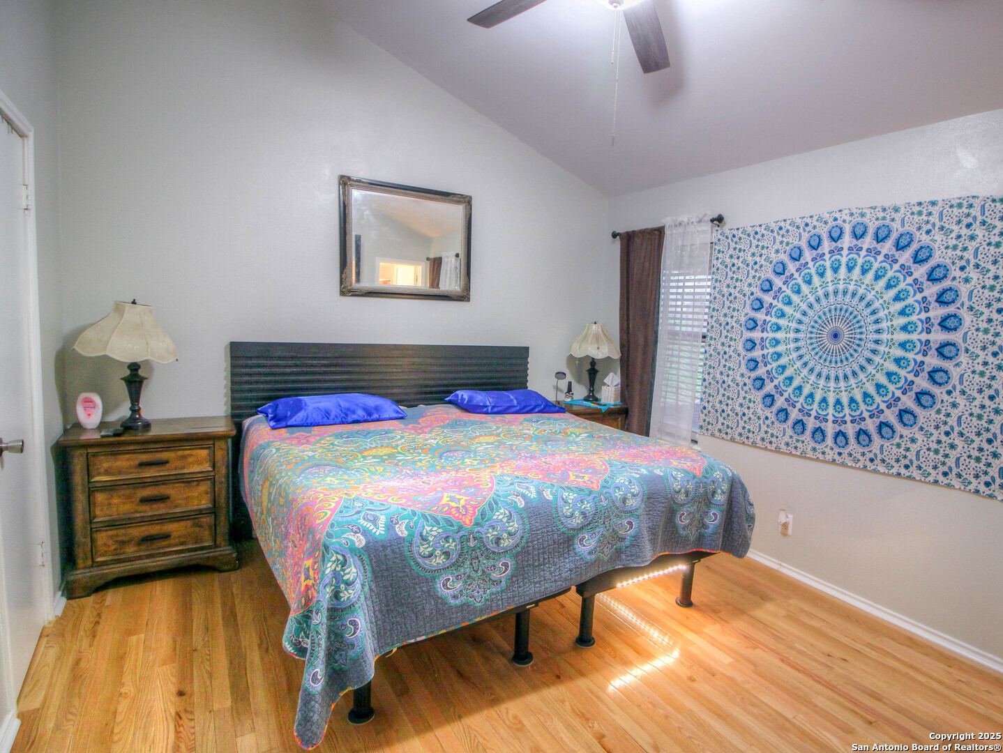 213 Bluebonnet Road La Vernia, TX 78121 - Photo 23 of 48 a bedroom with a bed and a lamp on dresser