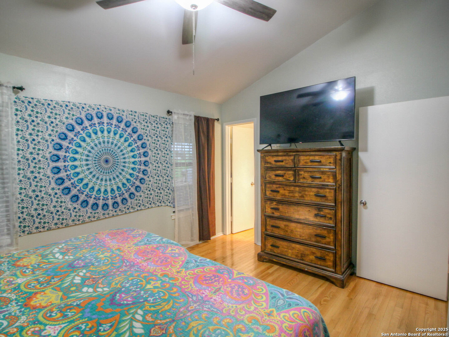 213 Bluebonnet Road La Vernia, TX 78121 - Photo 24 of 48 a bedroom with a bed and a flat screen tv