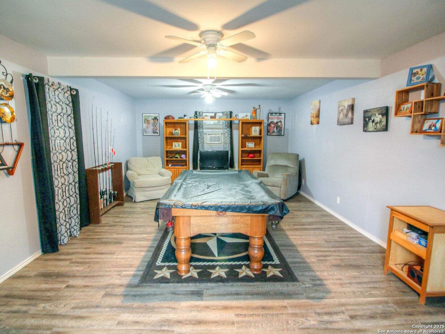 213 Bluebonnet Road La Vernia, TX 78121 - Photo 30 of 48 a living room with lots of furniture and a rug