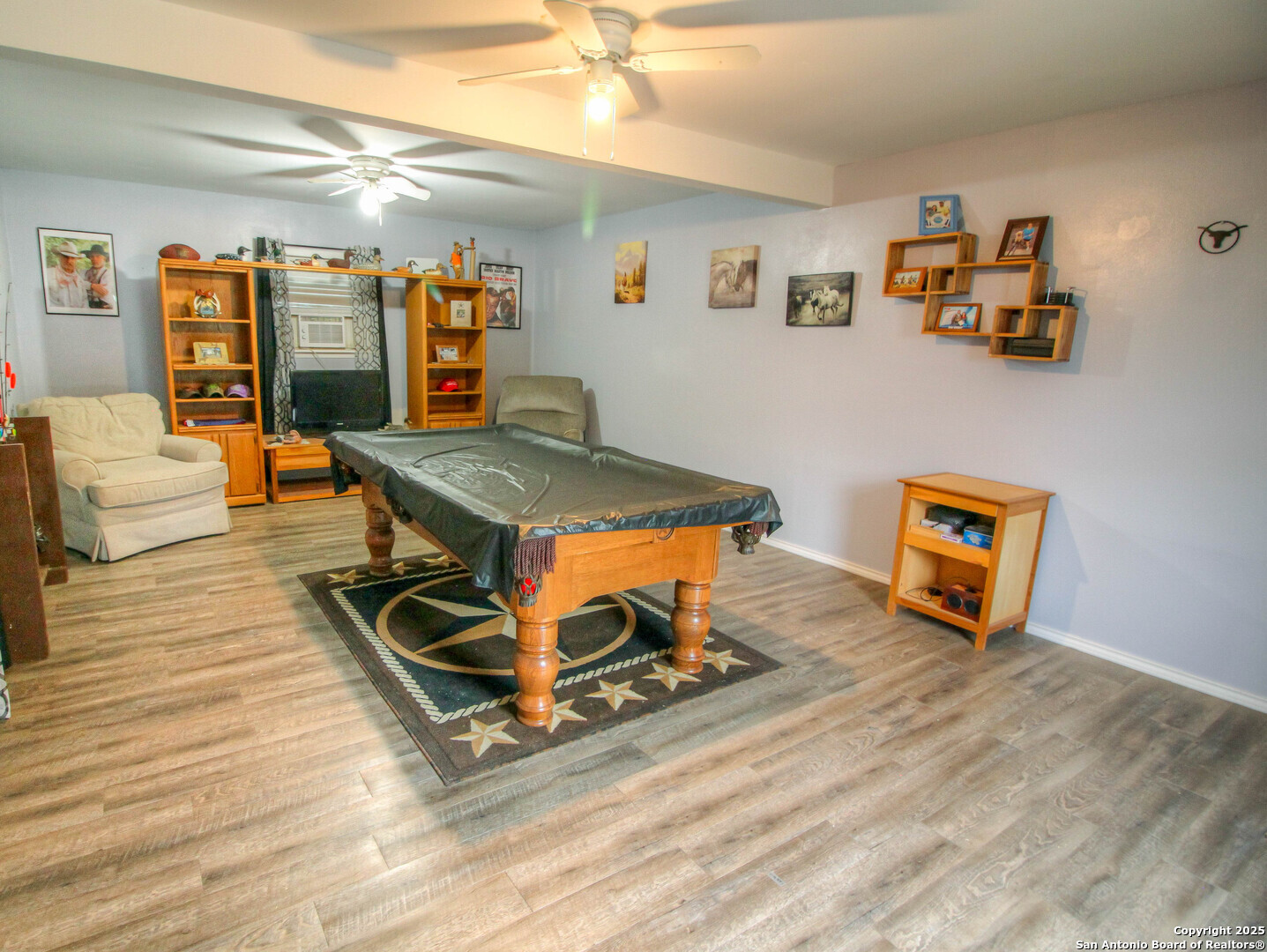 213 Bluebonnet Road La Vernia, TX 78121 - Photo 32 of 48 a living room with furniture and wooden floor