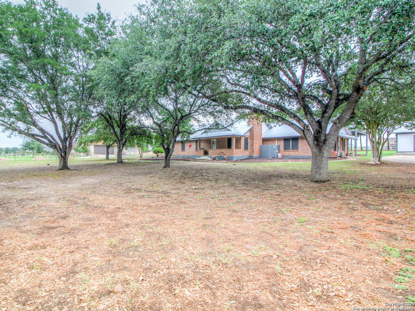 213 Bluebonnet Road La Vernia, TX 78121 - Photo 41 of 48 a house with trees in front of it