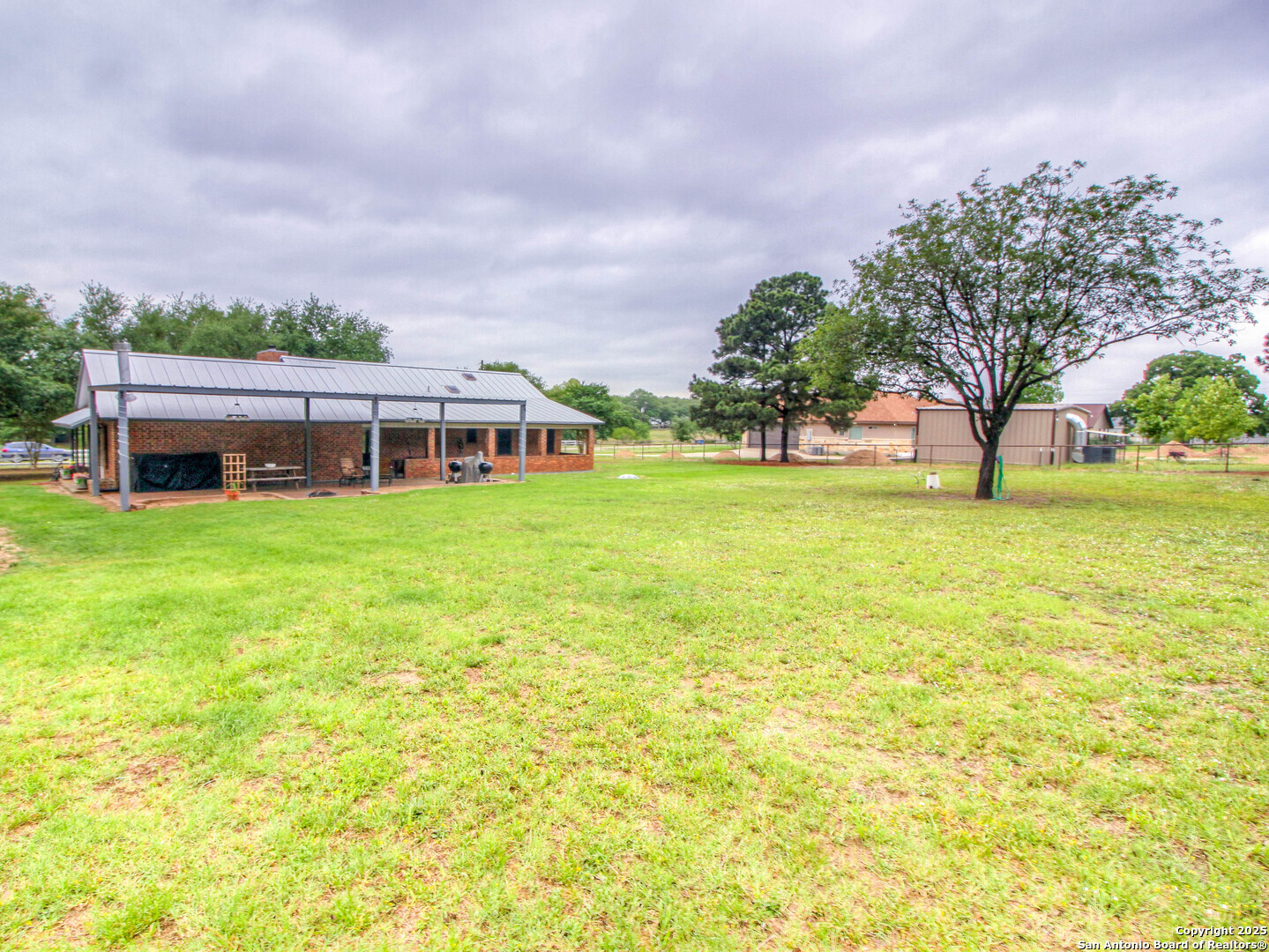 213 Bluebonnet Road La Vernia, TX 78121 - Photo 42 of 48 a view of a house with a big yard and large trees