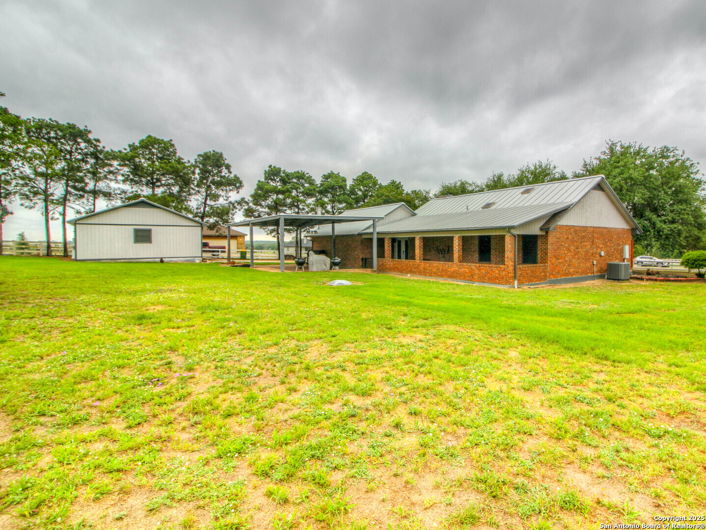 213 Bluebonnet Road La Vernia, TX 78121 - Photo 43 of 48 a view of a house with a big yard and large trees
