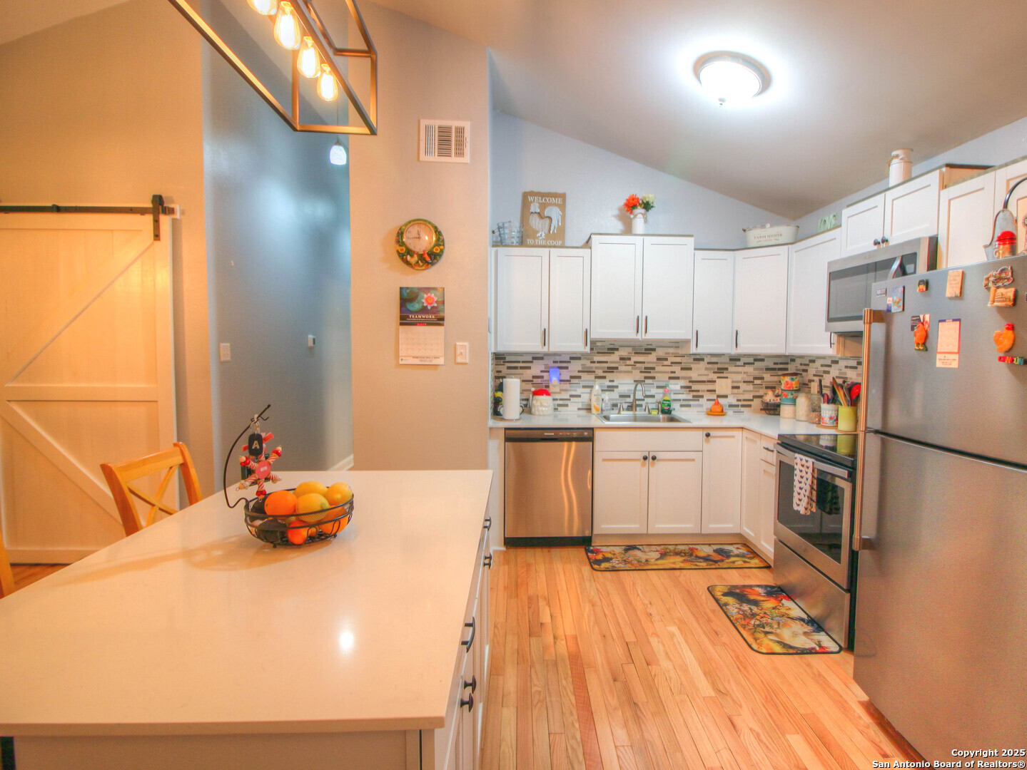 213 Bluebonnet Road La Vernia, TX 78121 - Photo 6 of 48 a kitchen with stainless steel appliances a refrigerator and a stove top oven