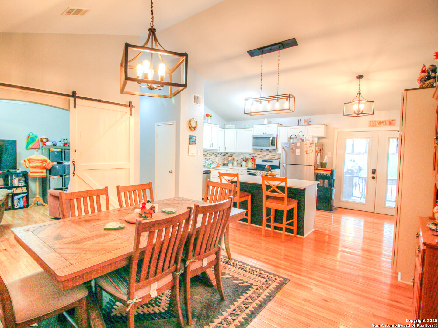 213 Bluebonnet Road La Vernia, TX 78121 - Photo 7 of 48 a dining room with furniture a chandelier and wooden floor