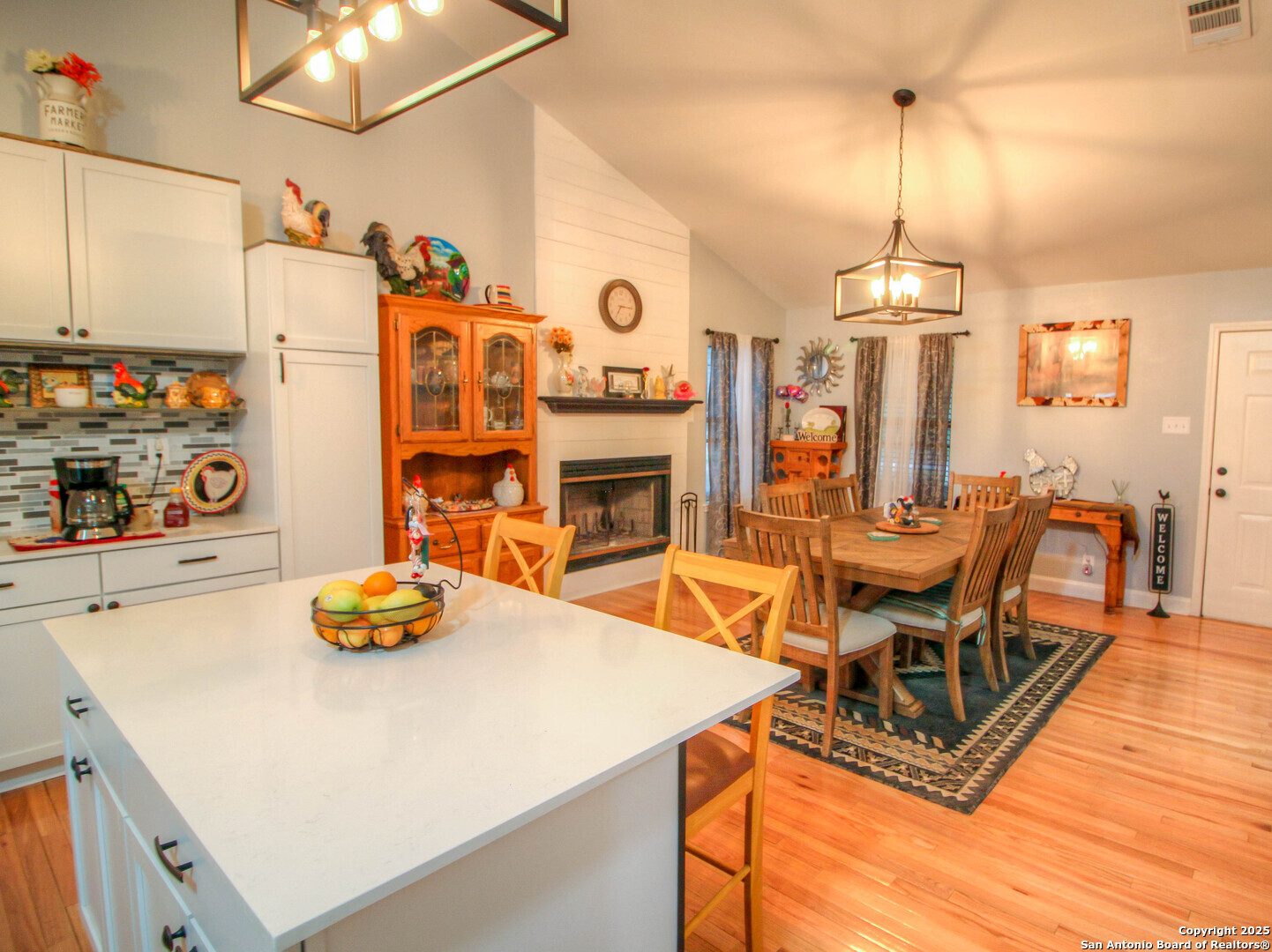 213 Bluebonnet Road La Vernia, TX 78121 - Photo 10 of 48 a view of a dining room with furniture a chandelier and wooden floor