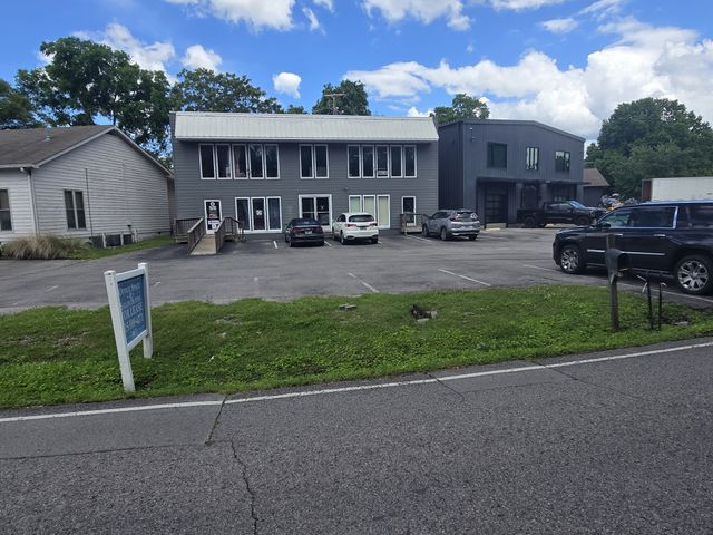 a view of a house with a yard and sitting area