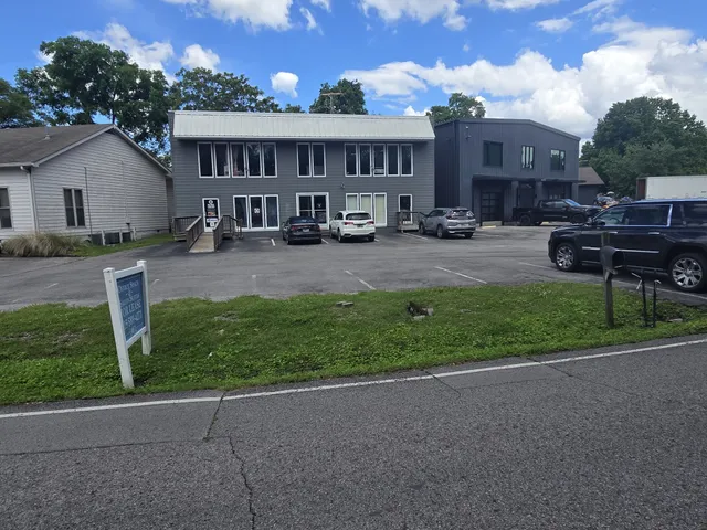 a view of a house with a yard and sitting area