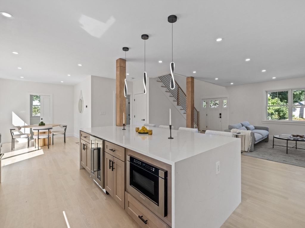 10 Ames Street Wakefield, MA 01880 - Photo 15 of 42 a large room with stainless steel appliances kitchen island a stove and a wooden floors