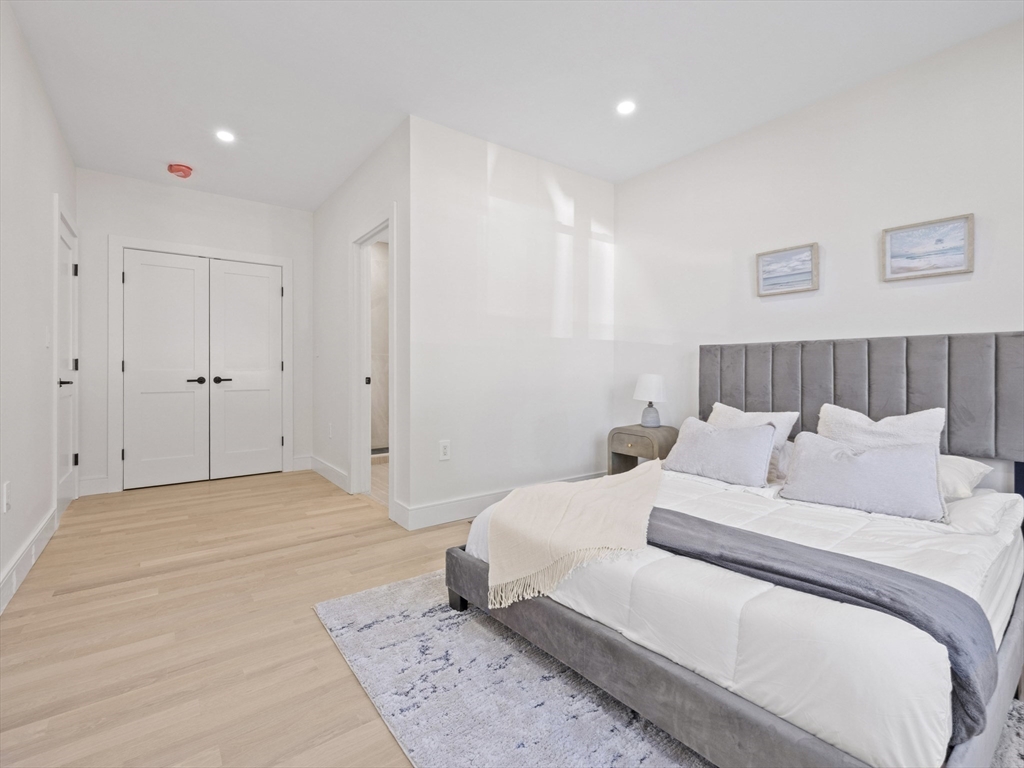 10 Ames Street Wakefield, MA 01880 - Photo 21 of 42 a bedroom with a bed and a night stand