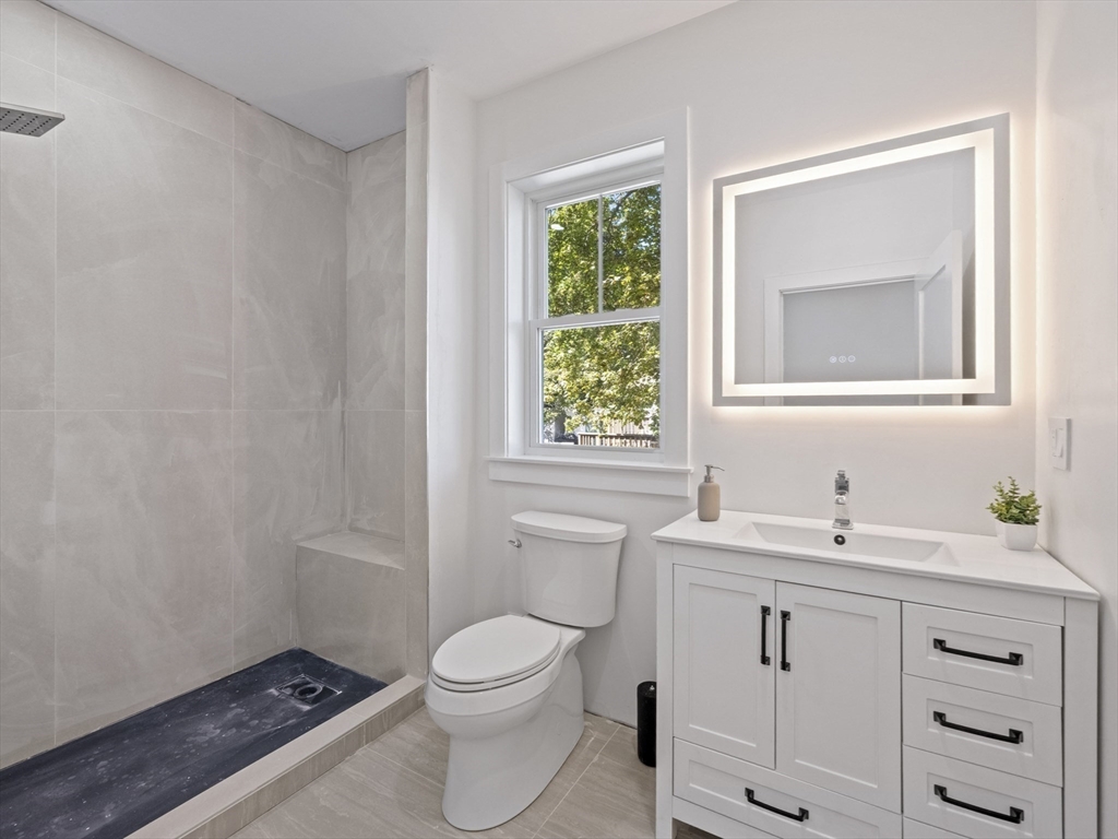 10 Ames Street Wakefield, MA 01880 - Photo 22 of 42 a bathroom with a sink toilet vanity and window