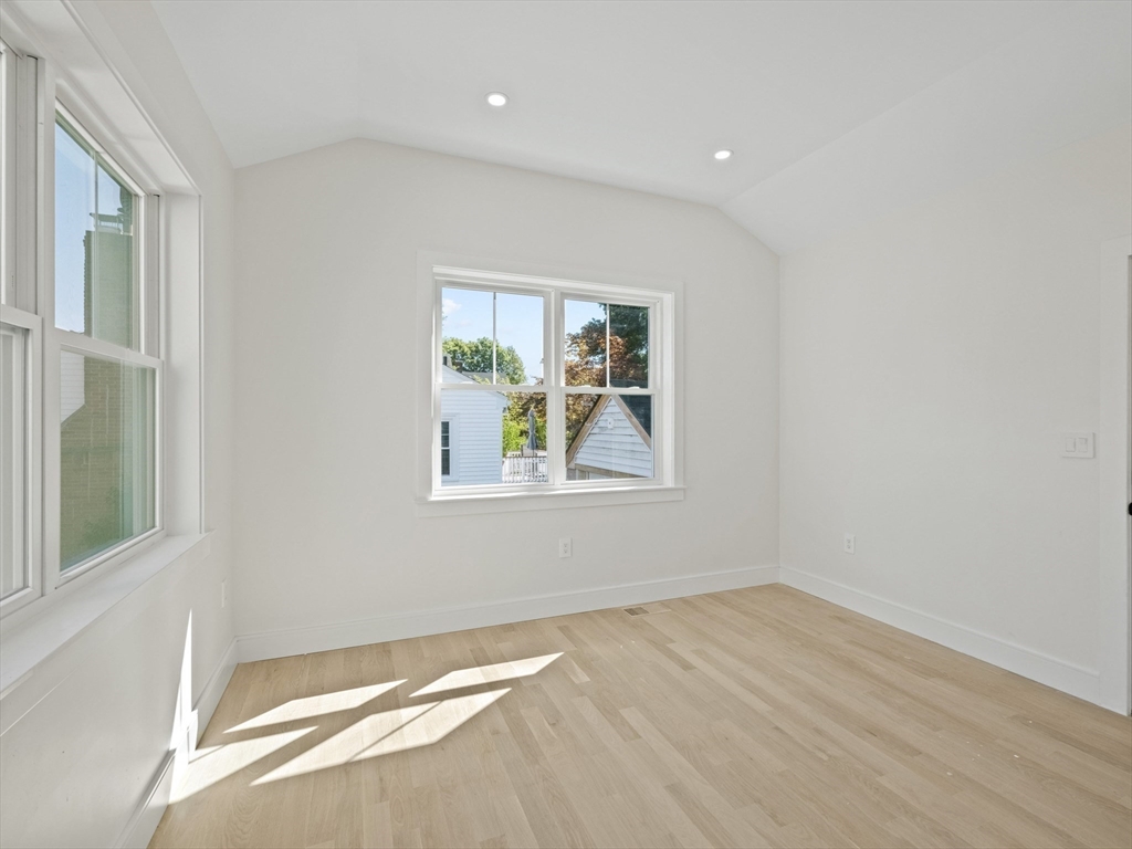 10 Ames Street Wakefield, MA 01880 - Photo 25 of 42 an empty room with wooden floor and windows