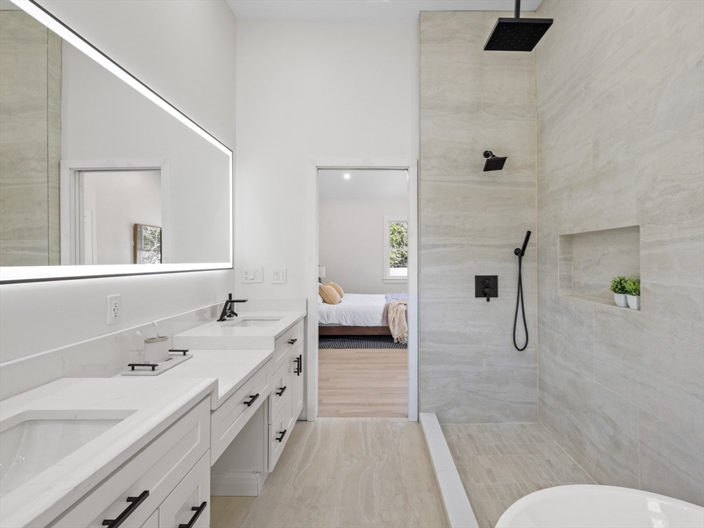 10 Ames Street Wakefield, MA 01880 - Photo 29 of 42 a en suite bathroom with a double vanity sink a mirror and shower