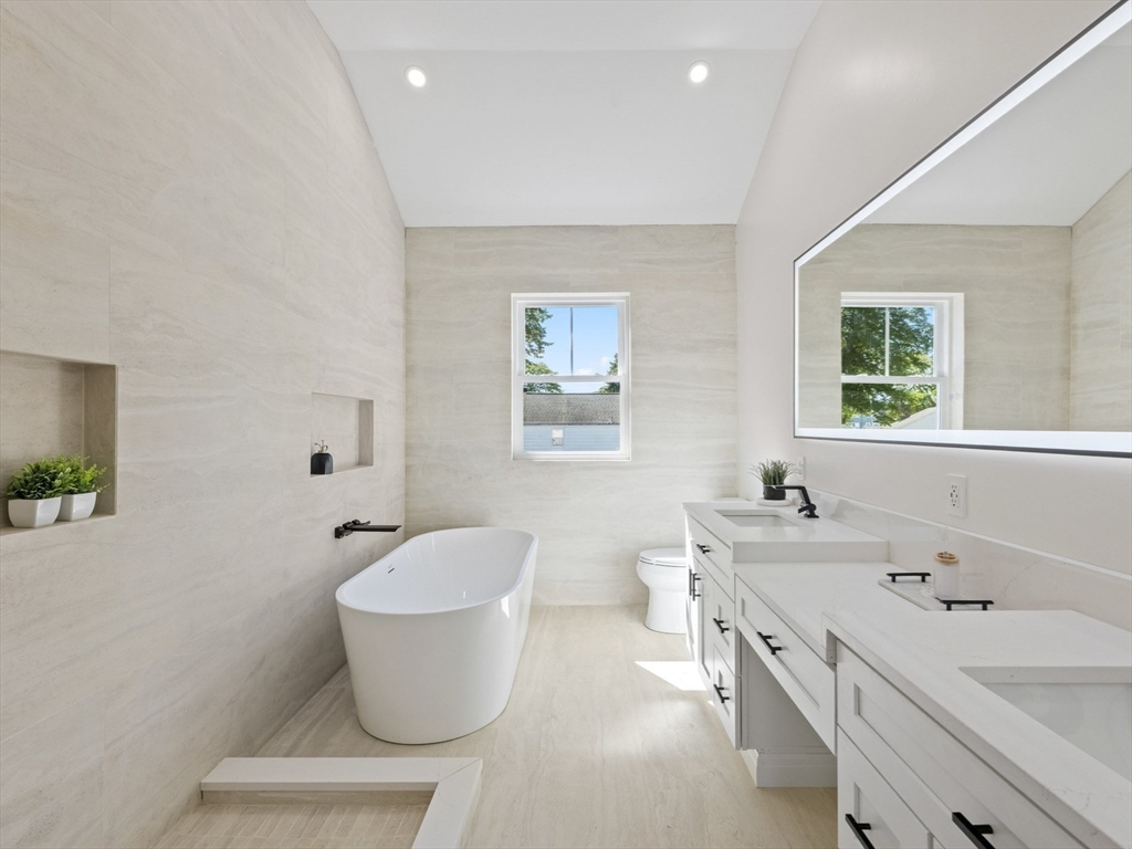 10 Ames Street Wakefield, MA 01880 - Photo 31 of 42 a bathroom with a toilet sink and mirror