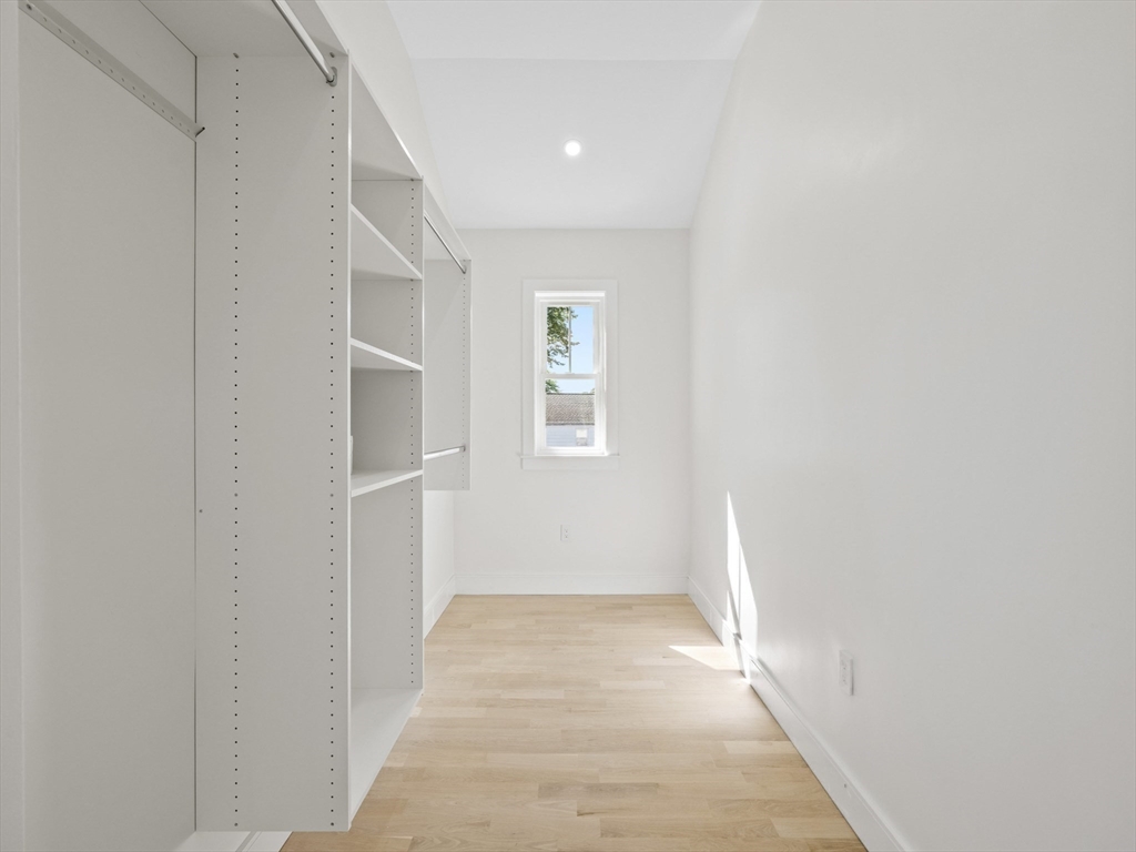 10 Ames Street Wakefield, MA 01880 - Photo 32 of 42 a view of a hallway with wooden floor and a window