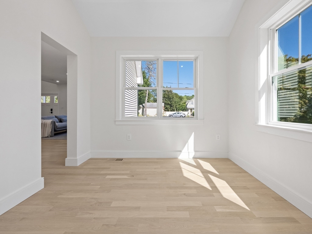 10 Ames Street Wakefield, MA 01880 - Photo 33 of 42 a view of empty room with wooden floor and fan