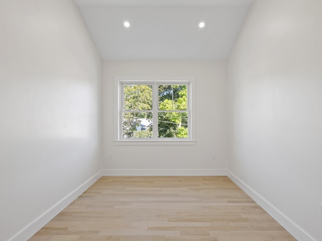 10 Ames Street Wakefield, MA 01880 - Photo 36 of 42 an empty room with wooden floor and windows