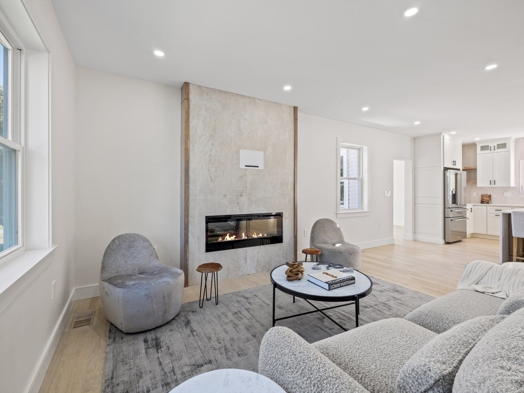 10 Ames Street Wakefield, MA 01880 - Photo 7 of 42 a living room with furniture and a fireplace
