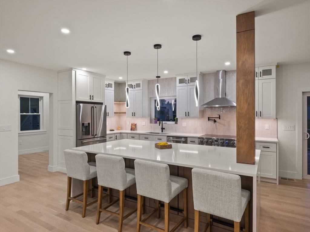 10 Ames Street Wakefield, MA 01880 - Photo 10 of 42 a kitchen with kitchen island wooden cabinets and refrigerator