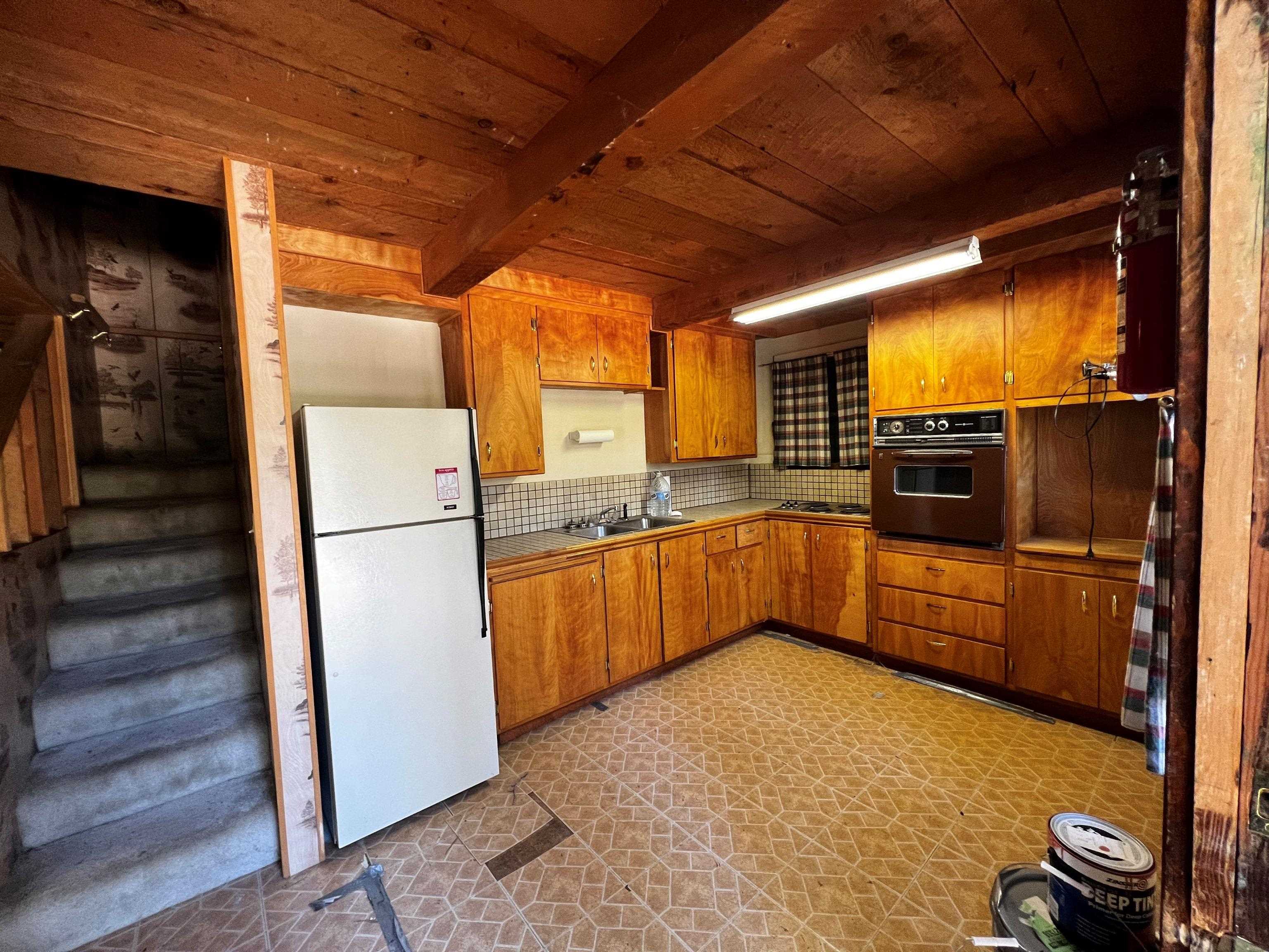23 Haskell Creek Road, Unit 23 Calpine, CA 96124 - Photo 3 of 15 a kitchen with a refrigerator and a stove