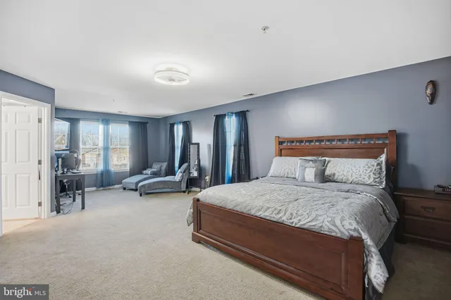 a bedroom with a workspace