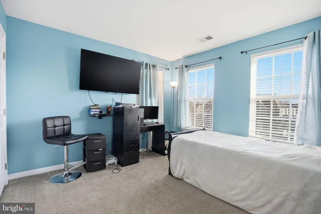 a bathroom with a sink a toilet a shower curtain and a mirror