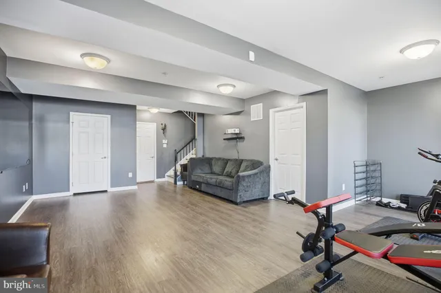 a view of a dining room and livingroom with furniture wooden floor a chandelier