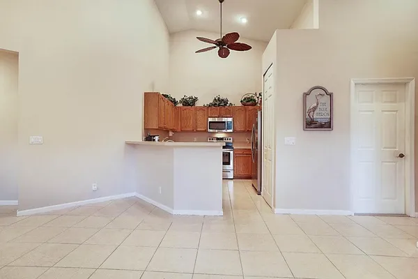 a kitchen with kitchen island white cabinets and stainless steel appliances
