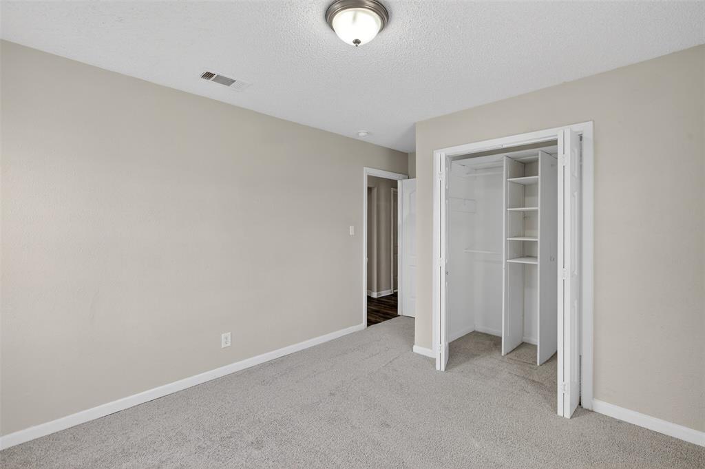 701 Harrison Lane Hurst, TX 76053 - Photo 11 of 29 a view of an empty room with closet and a window