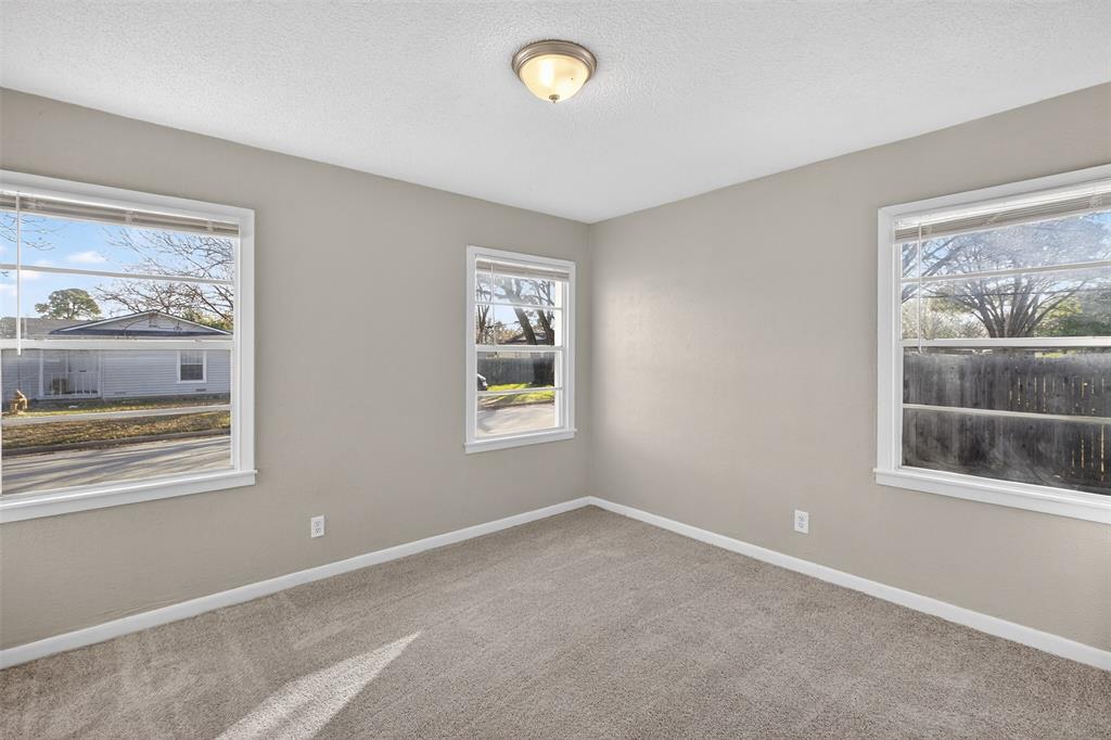 701 Harrison Lane Hurst, TX 76053 - Photo 12 of 29 a view of empty room with window and fireplace