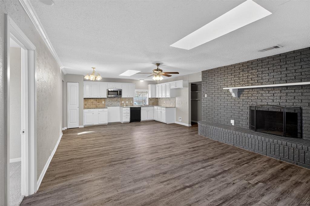 701 Harrison Lane Hurst, TX 76053 - Photo 16 of 29 a view of a kitchen with wooden floor and a kitchen