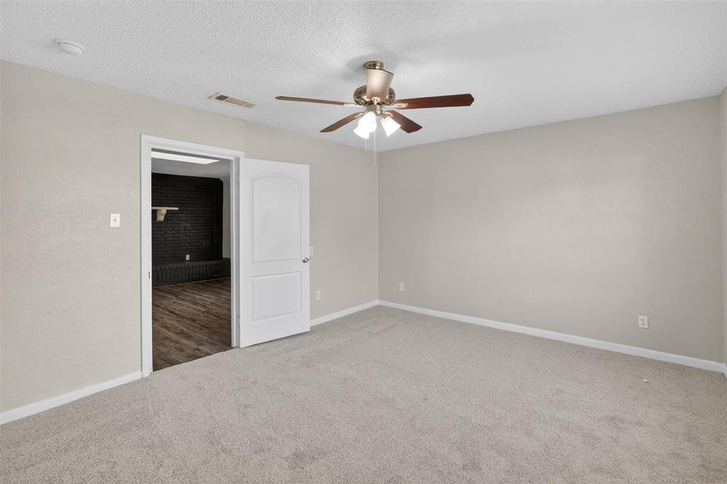 701 Harrison Lane Hurst, TX 76053 - Photo 18 of 29 an empty room with closet and fan