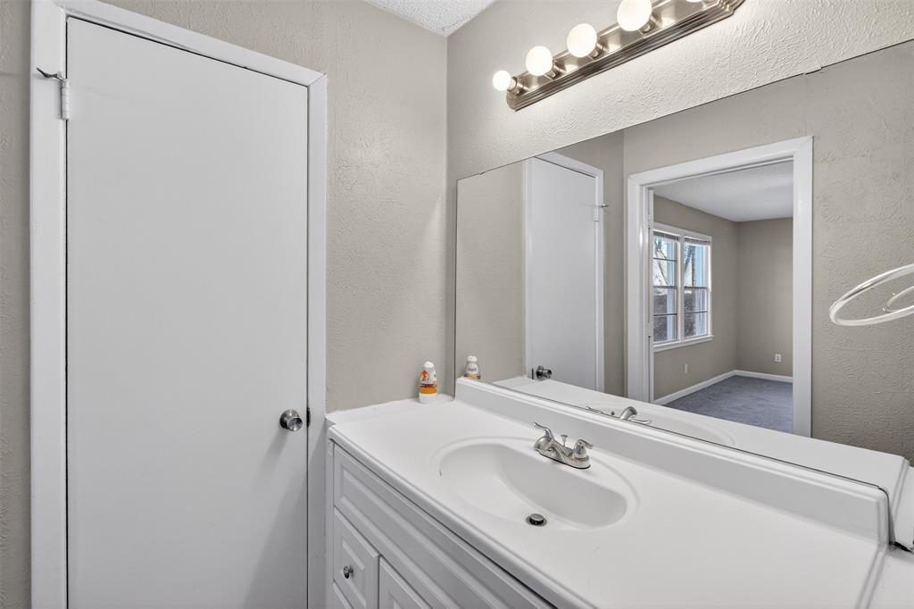 701 Harrison Lane Hurst, TX 76053 - Photo 20 of 29 a bathroom with a sink and a mirror