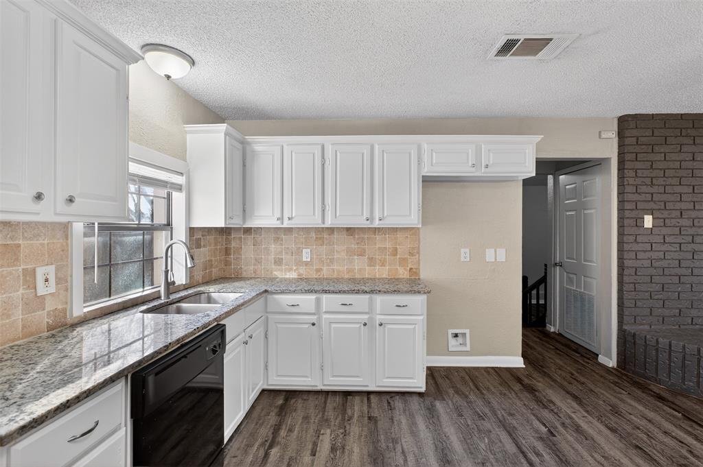 701 Harrison Lane Hurst, TX 76053 - Photo 24 of 29 a kitchen with a sink window and cabinets